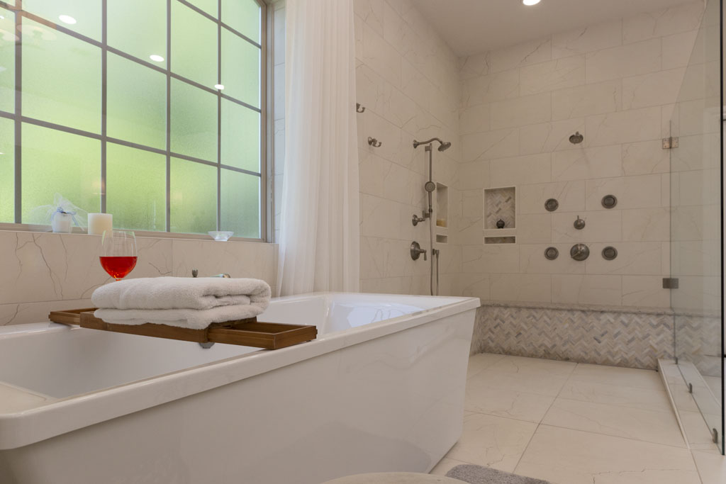 Freestanding tub and frameless walk-in shower in master bathroom remodel San Antonio