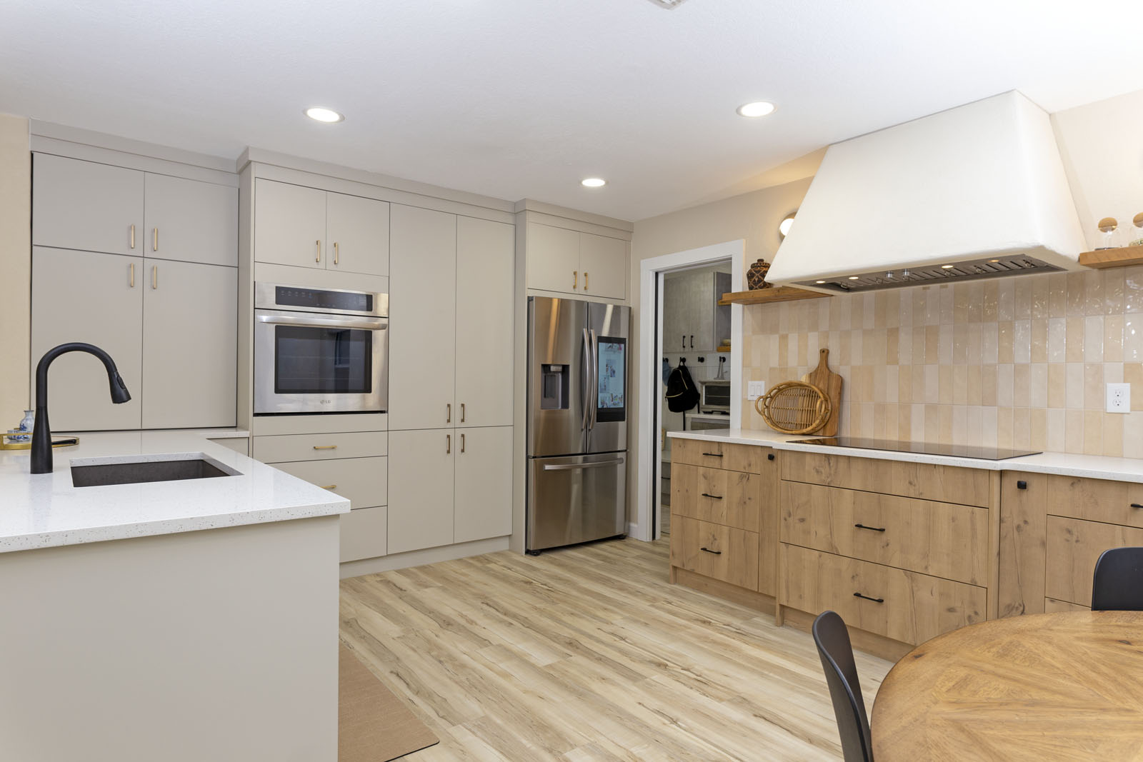 Modern kitchen remodel after on the far west side of San Antonio with white cabinetry and quartz island
