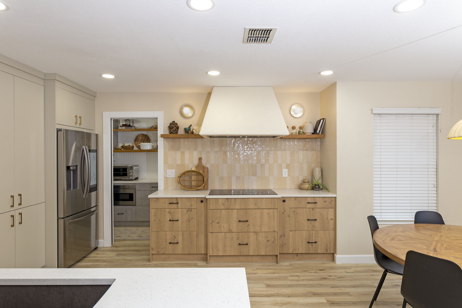Open concept kitchen remodel San Antonio with custom tile backsplash and modern vent hood