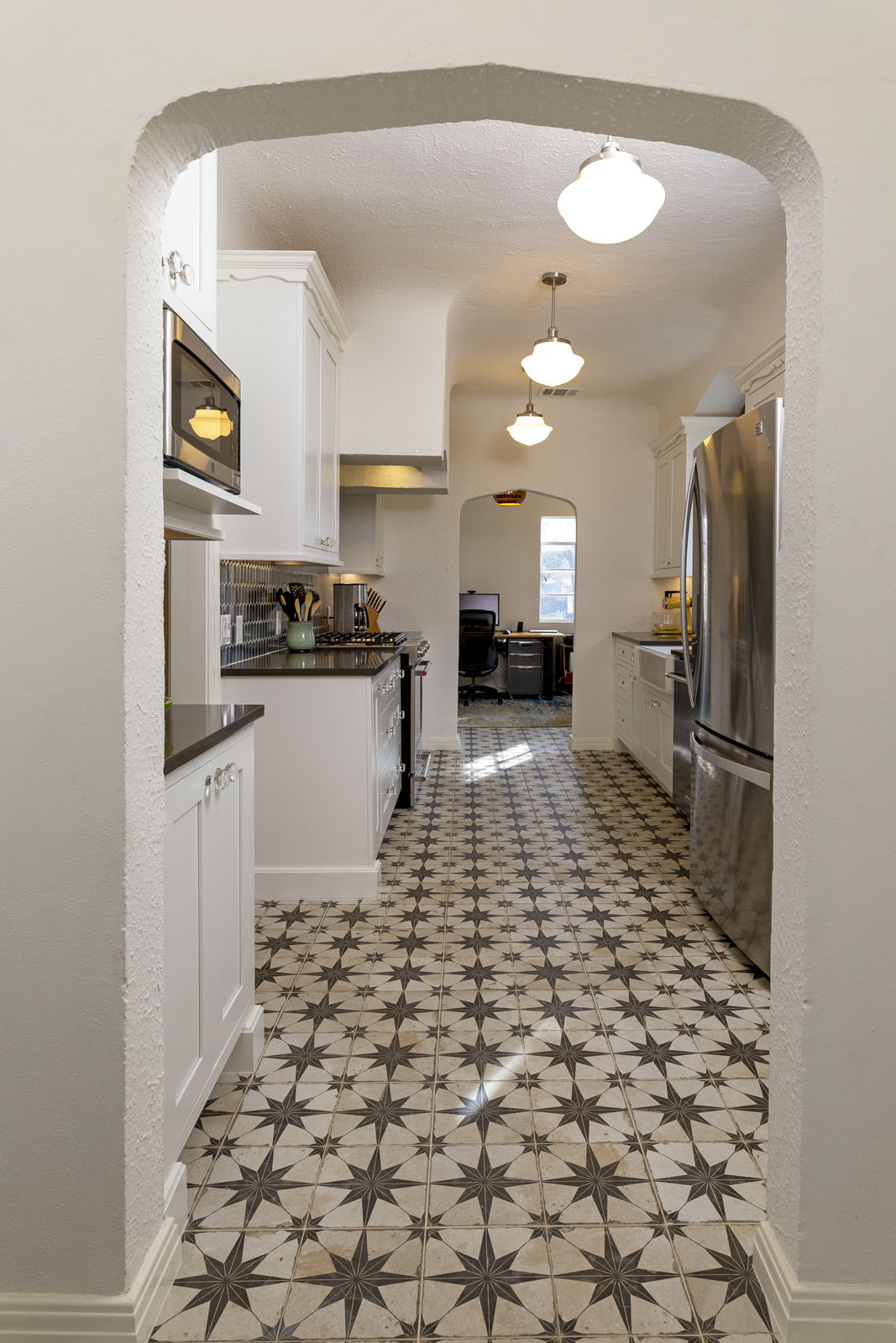 After kitchen remodel San Antonio TX showing white cabinets with blue elongated hexagon backsplash