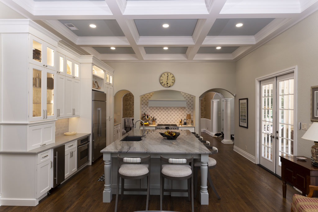 Modern kitchen remodel after in San Antonio Oak Park Northwood with floor-to-ceiling cabinets and large vent hood
