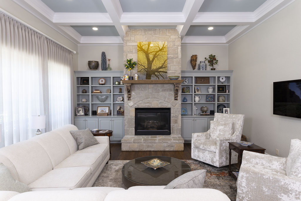 Living and dining area in San Antonio Oak Park Northwood home with light blue accent shelving after remodel