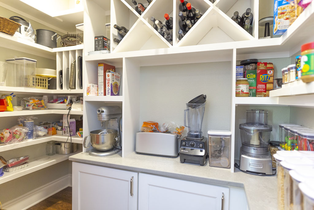 Walk-in pantry remodel in San Antonio with full-height cabinetry and wine storage shelving