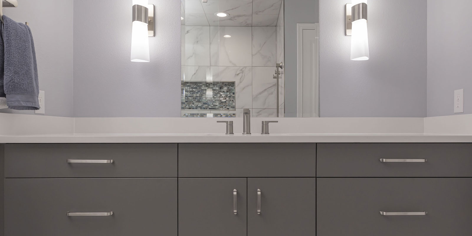 Contemporary bathroom remodel on the far north side of San Antonio with dual vanity, quartz countertop, and modern walk-in shower