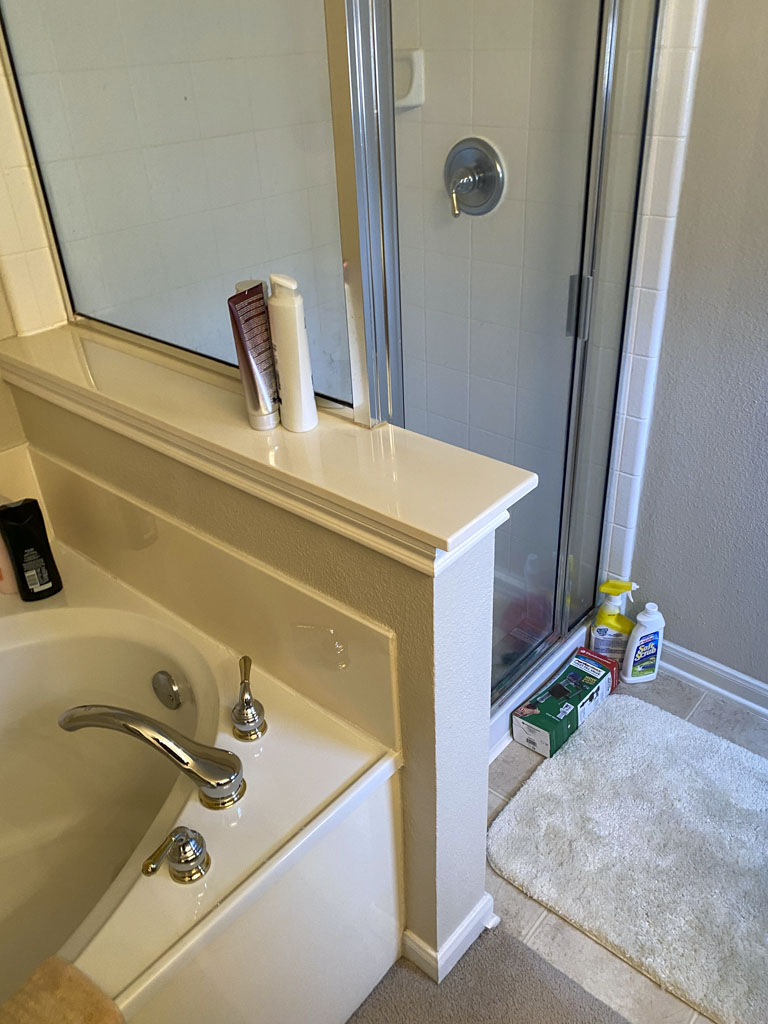 Before narrow bathroom remodel San Antonio with limited counter space and dated finishes