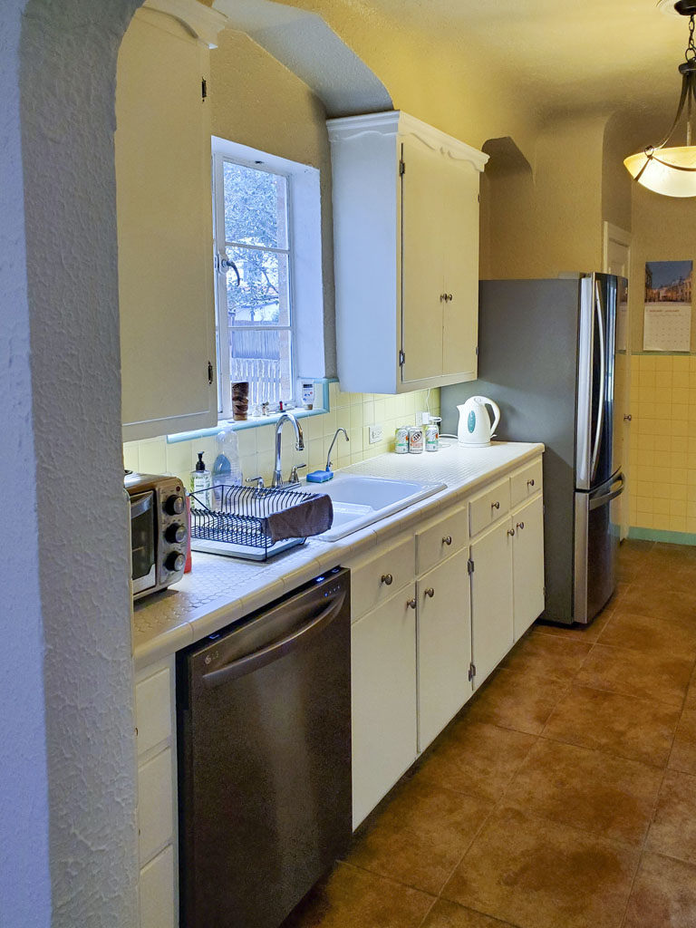 Before photo of original 1939 kitchen in Monticello Park San Antonio with vintage yellow tile backsplash