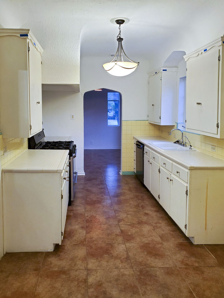 Before kitchen remodel San Antonio TX showing white cabinets with crown molding and brushed nickel hardware