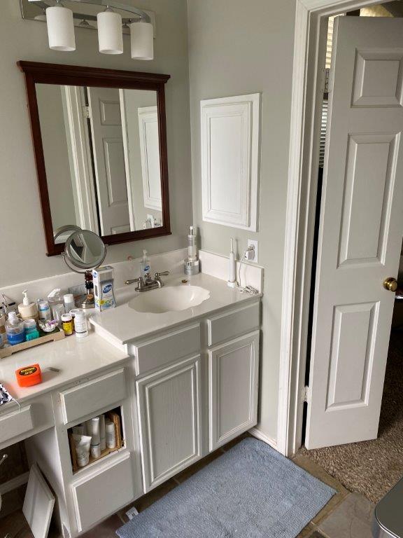 Before bathroom remodel San Antonio - dated tub-shower combo and brown tile flooring