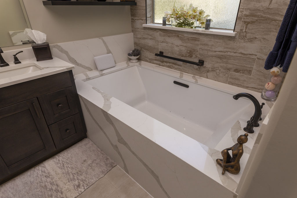 Soaking tub with Calcatta Bali Quartz surround in transitional master bathroom remodel San Antonio