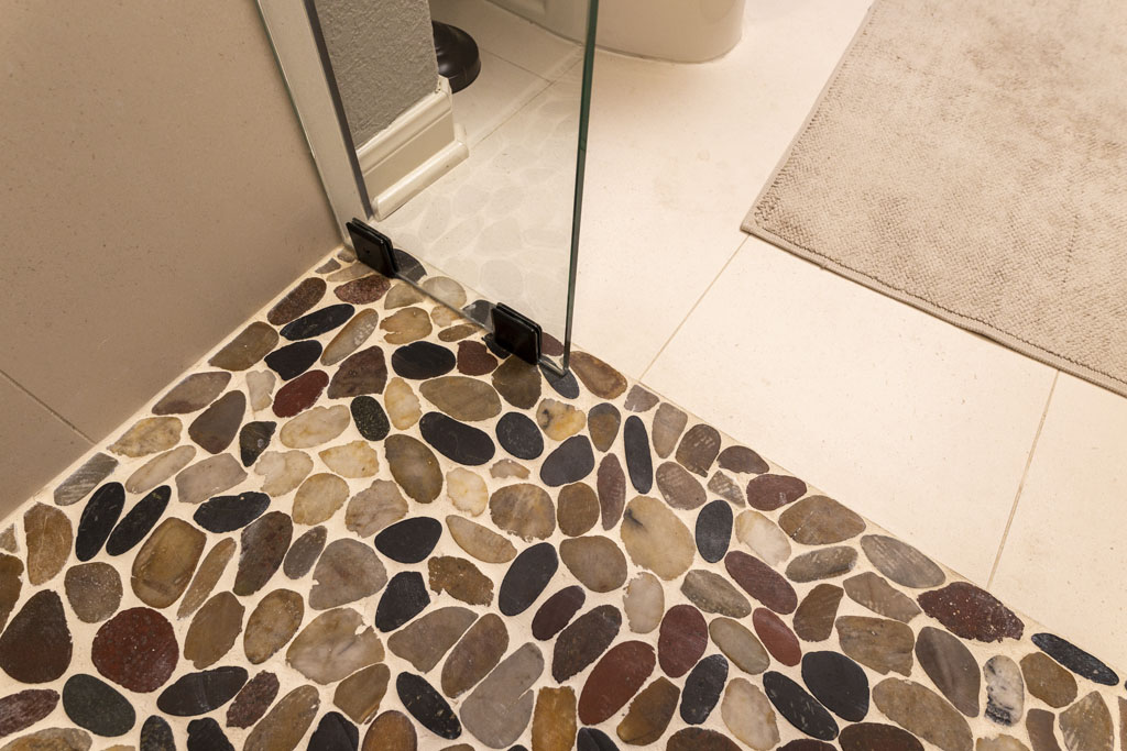 Rivera Pebbles shower floor tile by Emser Tile in transitional guest bathroom remodel San Antonio