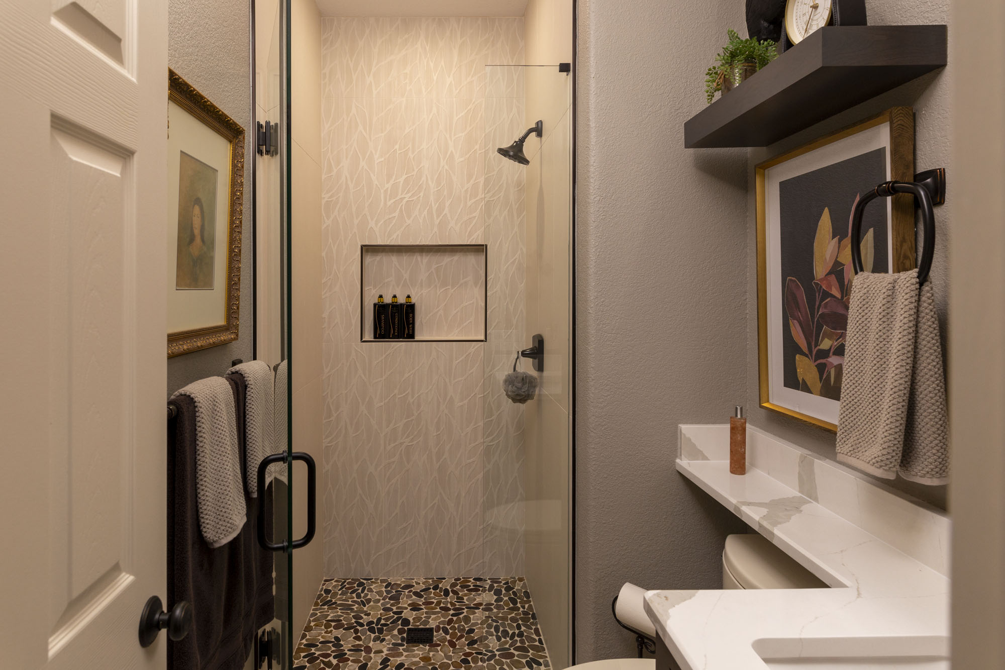Transitional guest bathroom remodel in San Antonio with frameless glass shower and oil-rubbed bronze fixtures